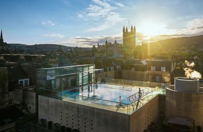 An aerial view of the rooftop pool at the Thermae Bath Spa in central Bath, with Bath's skyline in the background