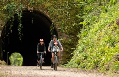A family cycling on the Strawberry Line path in North Somerset - credit Visit West