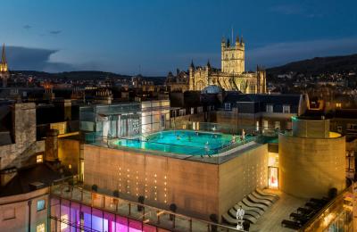An aerial view of the rooftop pool at the Thermae Bath Spa at night
