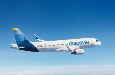 An image of a Discover Airlines plane flying through the sky.