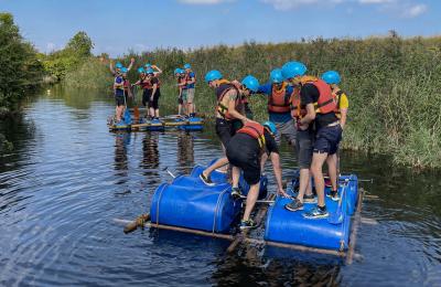 A group of men trying raft building at Mendip Activity Centre near Bristol - credit Mendip Activity Centre