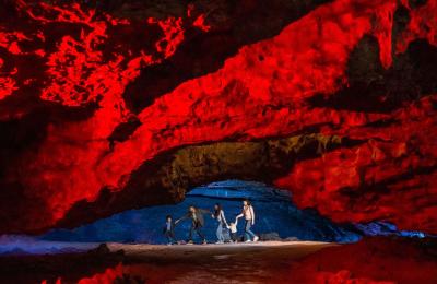 A family in a cave at Wookey Hole in Wells, near Bristol - credit Wookey Hole
