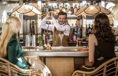 Two women watching a bartender prepare a cocktail at Rick's Bar on Bristol's Harbourside - credit Rick's