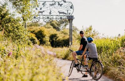 Two people on a tandem bike