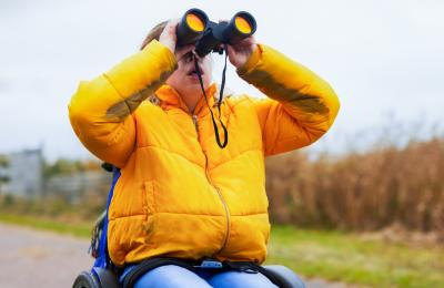 A wheelchair user birdwatching at WWT Slimbridge near Bristol - credit WWT Slimbridge