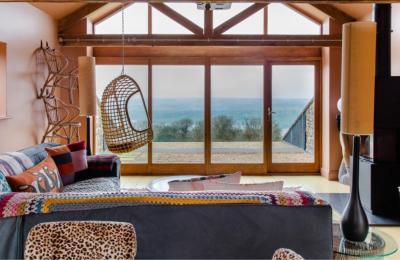 A room with a large window overlooking a countryside view at Yeo Valley Bristol
