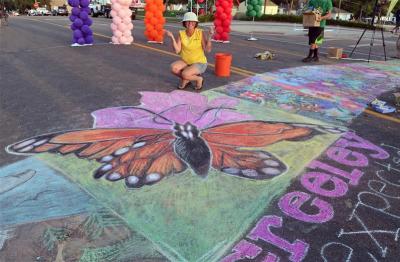 Woman posing with her chalk art at Chalk A Lot in 2015