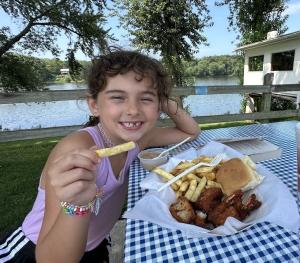 Picture of girl eating yummy food at the fence