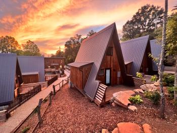 A-frame cabins at Wrong Way River Lodge & Cabins during sunset