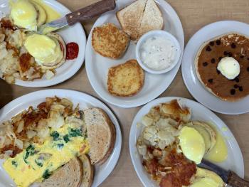View from above of various breakfast plates like scones, eggs and pancakes at George's Linworth Diner