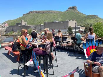 Group dining at Golden Mill Food Hall Overlooking Castle Rock in Golden, CO