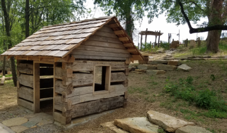 miniature log cabins for kids to play in at nature play at Behringer-Crawford Museum in covington ky