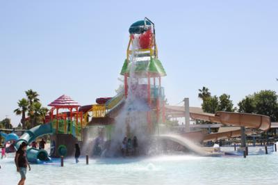Kids being splashed by large water fall at Island Water Park