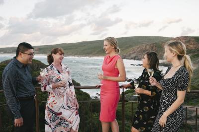 A group of business delegates on an incentive trip in Margaret River having drinks at Sugarloaf Rock