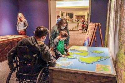 Visitors assemble a map of Pangea at RMSC's Expedition: Dinosaur