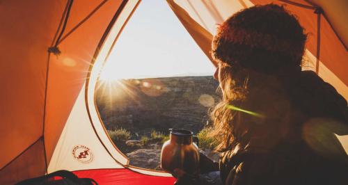 Camper looking out of tent near the San Rafael Swell