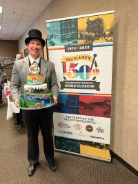 Birthday cake and banner for Eau Claire's 150th birthday