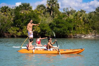 Family kayaking and standup paddleboarding in the waters of Stump Pass Beach State Park