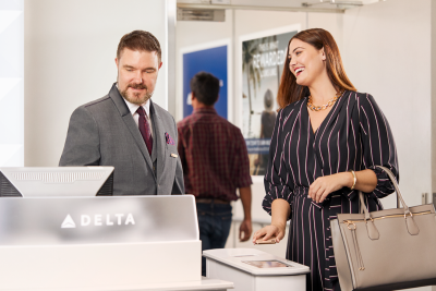 Woman checking in for flight with Delta Air Lines