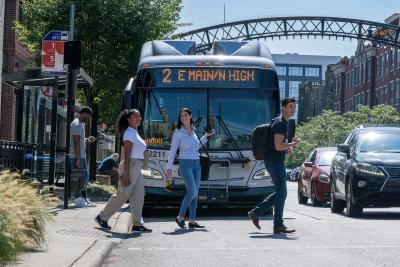 Three people getting off COTA bus in the Short North Arts District
