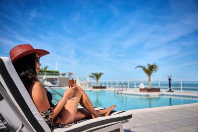 Woman relaxing at oceanfront pool deck in Daytona Beach