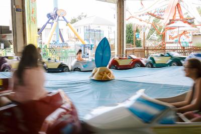 Funland's racing cars moving in a circle as rides can be seen in the background.