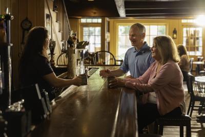 A couple sitting at the bar at Jessop's Tavern.