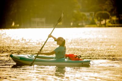 A woman kayaking at sunset in Cumberland County, NC.