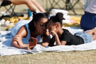 Young black woman and daughter taking a selfie in Festival Park