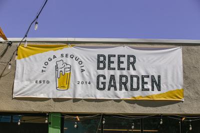 Sign hanging on building reads, "Tioga Sequoia Beer Garden"