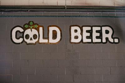 Sign that reads, "Cold Beer" and has skull art.