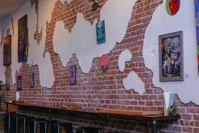 Brick wall with various art pieces hanging