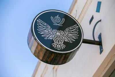 Outside sign with logo showing an owl with a crown