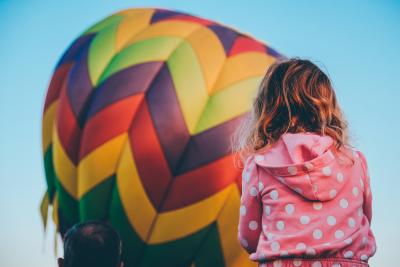 Young girl watches inflating hot air balloon