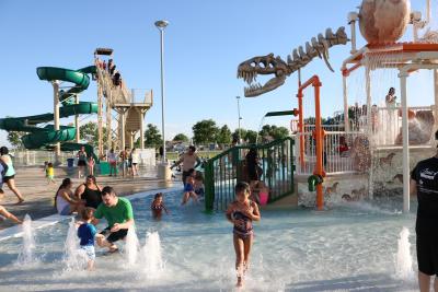 Discovery Bay Slide and Pool with children and adults playing
