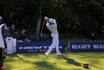 Golfer mid-swing with their driver at a golf ball to achieve the longest drive on the golf course