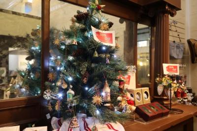 Photo of a small Christmas tree on a retail counter.