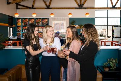four women making a toast at Cocoon Brewing in Green Bay, Wisconsin