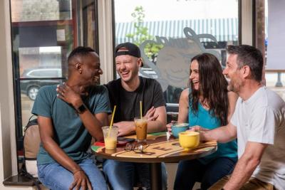 Group of friends enjoying Luna coffee in the shop