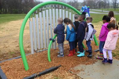Children playing on wind chimes at Schucks Regional Park Sensory Trail