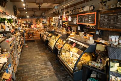 An image of the inside of Fromagination including their shelves of snacks and displays of specialty cheeses