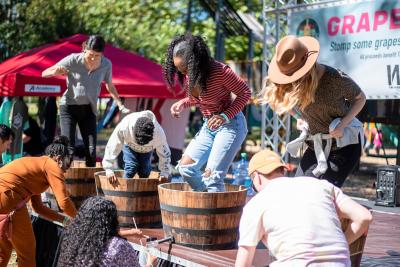 People stomping grapes at McKinney Wine & Music Festival