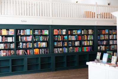Dark blue book shelves filled with books in a store