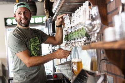 rocky reef bartender pouring a beer