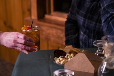 Old Fashioned served to a person at Norwood Pines Supper Club