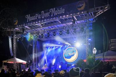 Large stage with musical acts, lights and MoonPie Over Mobile logo