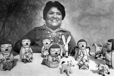 A Cochiti Pueblo potter shows off her storyteller figures in Santa Fe.