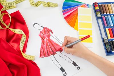 Person drawing a design for a new dress