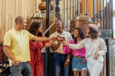 A group of five people enjoying a sample of Jeptha Creed bourbon on the Kentucky Bourbon Trail Craft Tour.
