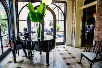 Man playing the piano during happy hour at the Southern Hotel, Covington